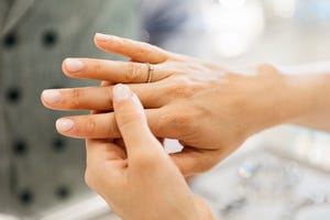 young attractive woman in a jewelry store trying on a diamond ring