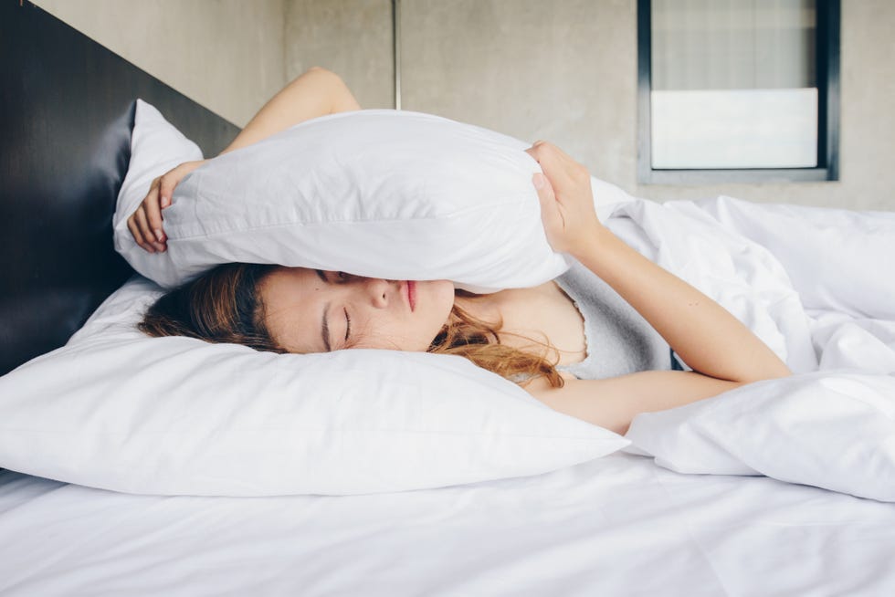 young beautiful asian woman hates waking up early in the morning