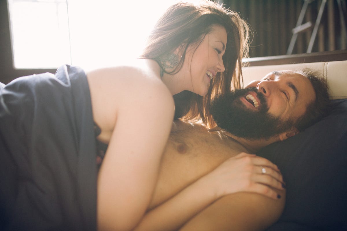 young beautiful man with a woman sleeping in the bed view from above