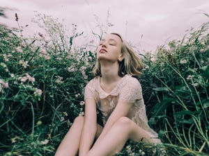 young beautiful woman enjoying the calm meadow