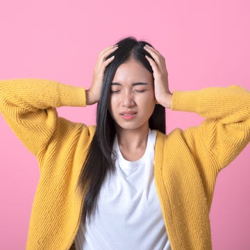 young beautiful woman wearing winter sweater over isolated background suffering from headache desperate and stressed because pain and migraine