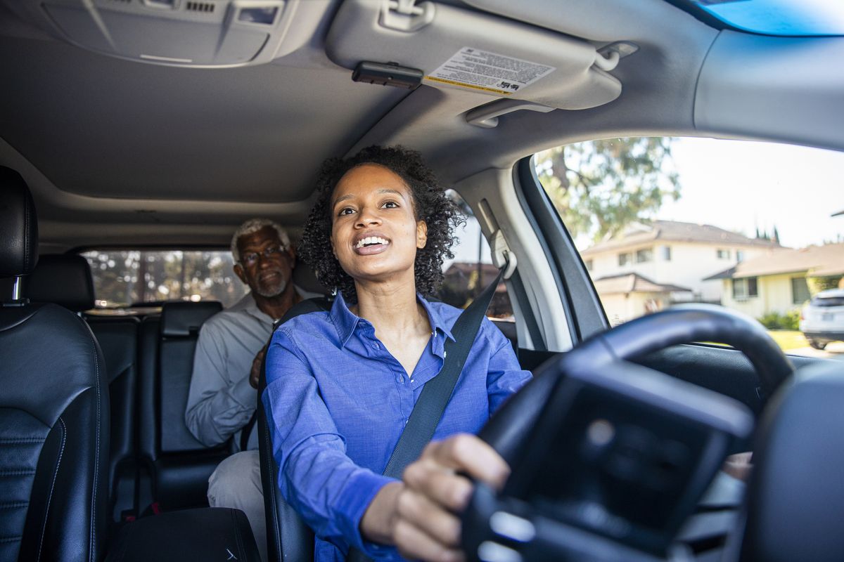 young black woman driving car for rideshare