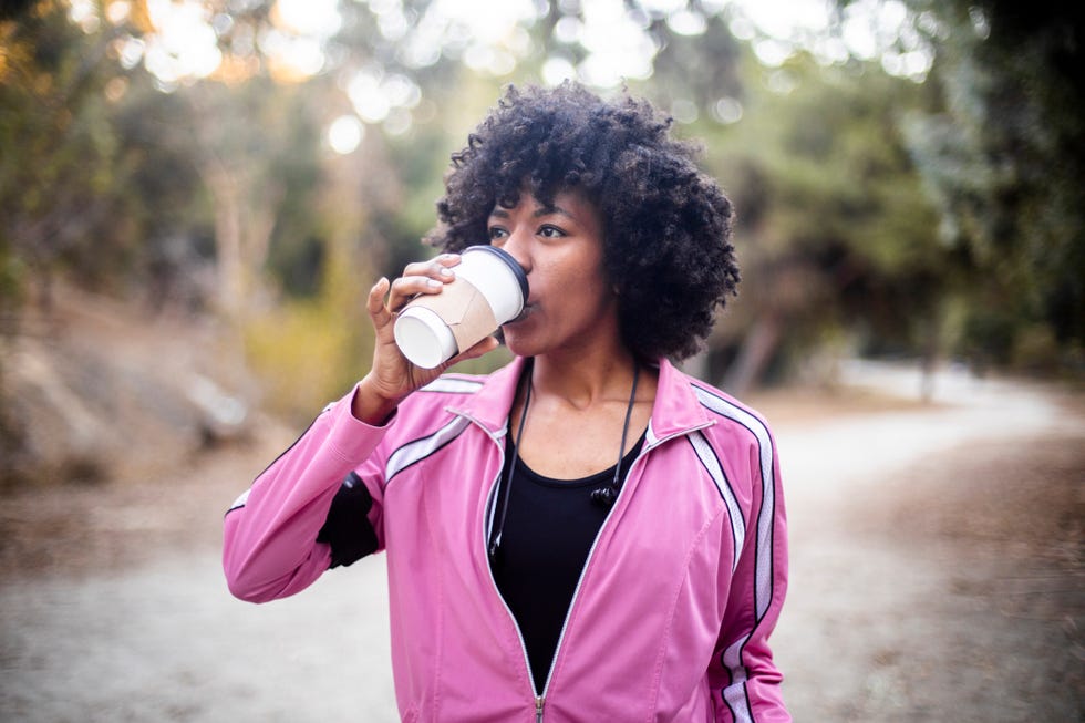 Young Black Woman Walking with Coffee