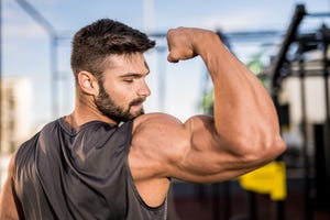 young bodybuilder flexing muscles at the gym