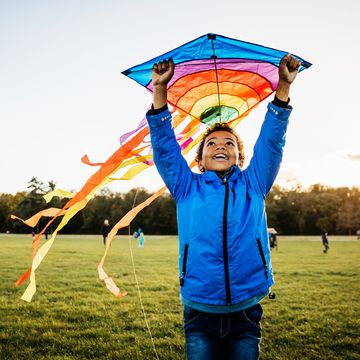 young boy enjoying learning how to fly kite
