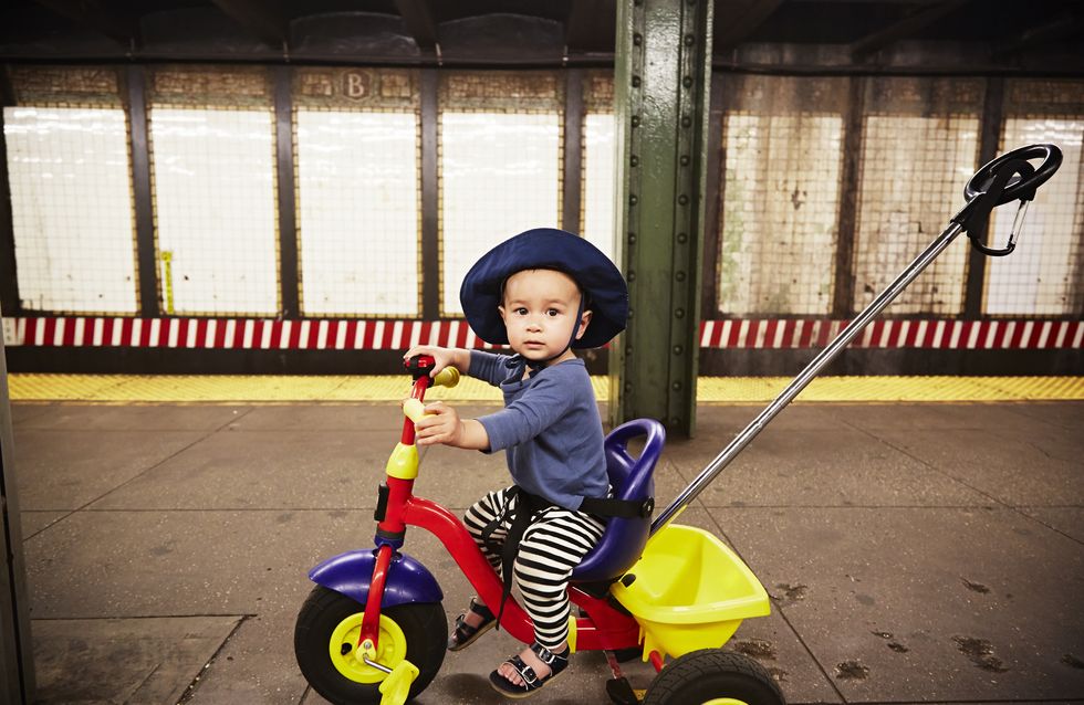 Young boy on tricycle in subway