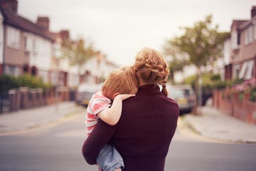 young boy resting on mother's shoulder