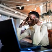 young businesswoman working with headache