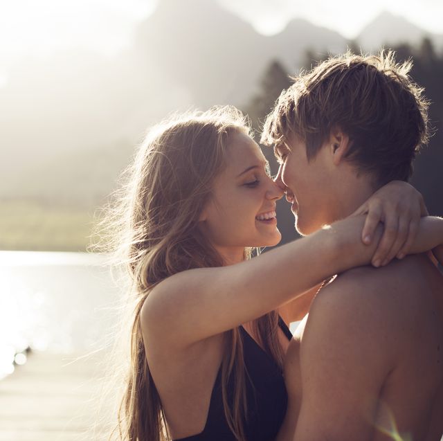 young couple about to kiss in a natural environmen