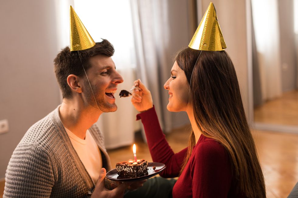 young couple celebrating birthday at home