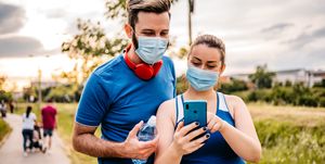 young couple checking fitness activity on phone