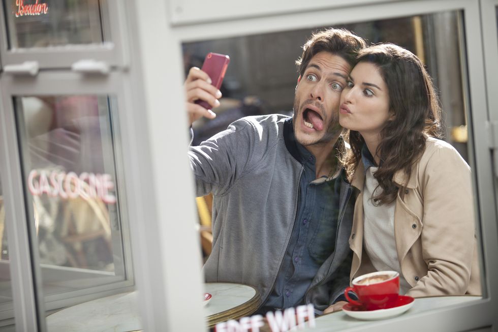 young couple doing a selfie in a cafe