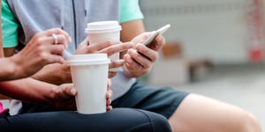 Young couple drinking coffee to go