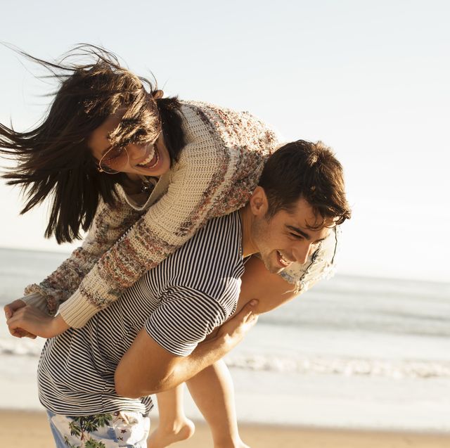 young couple fooling around on beach