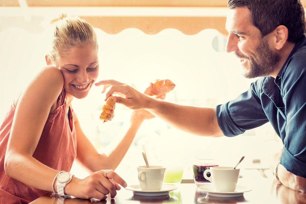 Young couple has breakfast at italian café