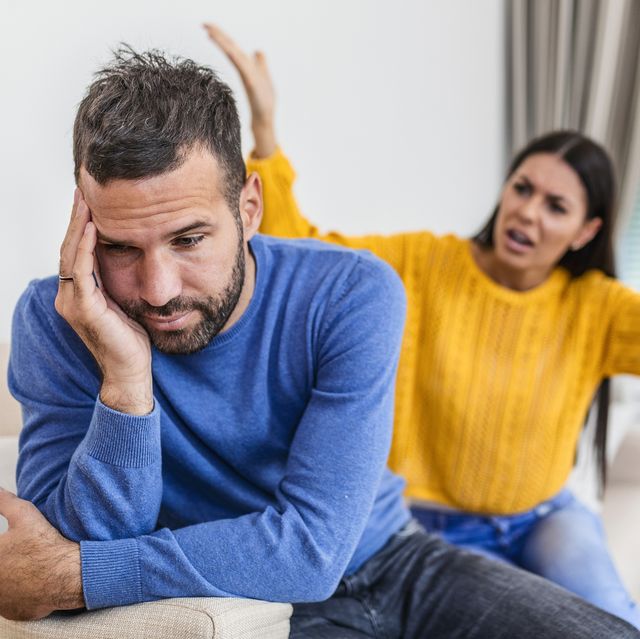 young couple having argument conflict, bad relationships angry fury woman angry young couple sit on couch in living room having family fight or quarrel suffer from misunderstanding