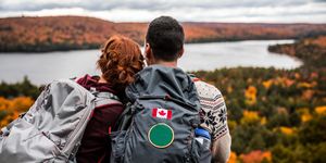 young couple hiking in mountain and relaxing looking at view