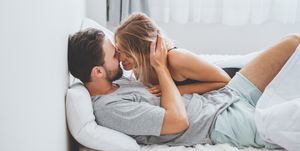 young couple kissing on bed
