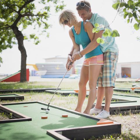 fun summer date ideas to enjoy with your partner 
 young couple playing mini golf