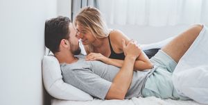 young couple romancing in bedroom at home