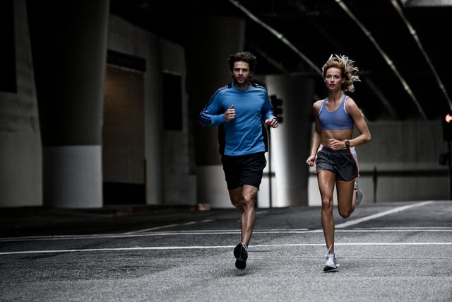young couple running in the city