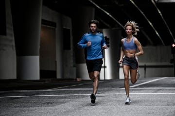 young couple running in the city