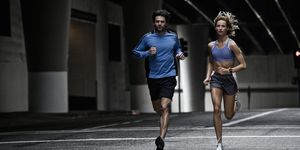young couple running in the city