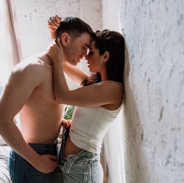 young couple standing against wall