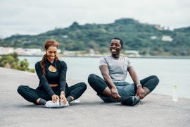 young couple stretching before or after running or jogging
