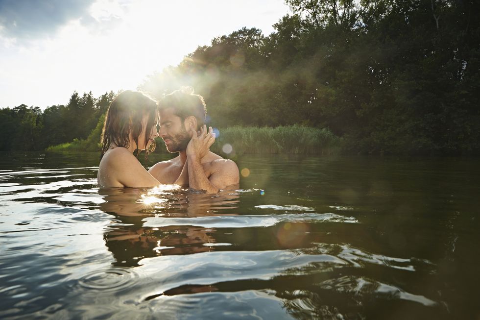 young couple swimming in lake