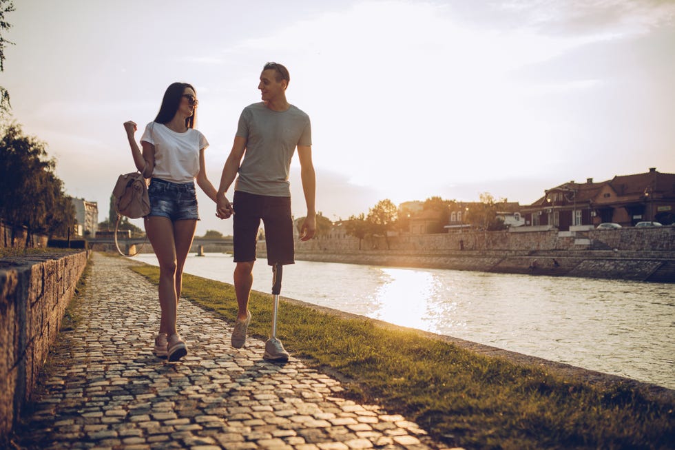 young couple walking by the river