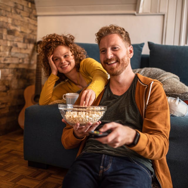 young couple watching a movie at home