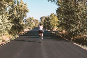 young female cyclist road bike ride