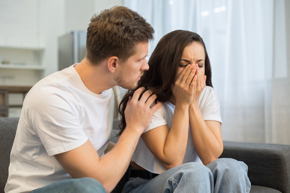 young depressed crying lady with boyfriend at home
