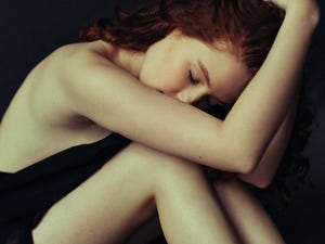 young depressed woman sitting alone