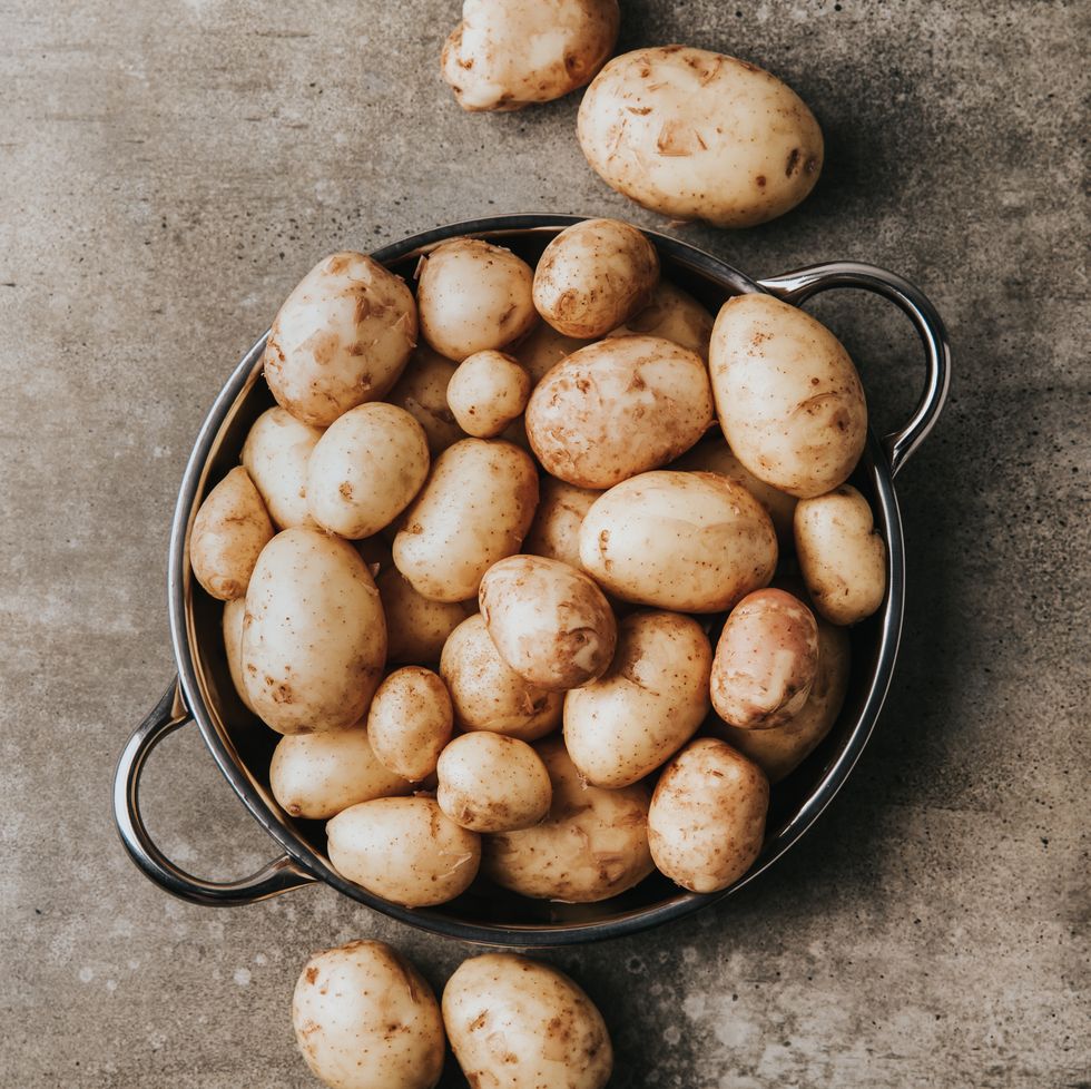 young farm potatoes. raw potato on a table.
