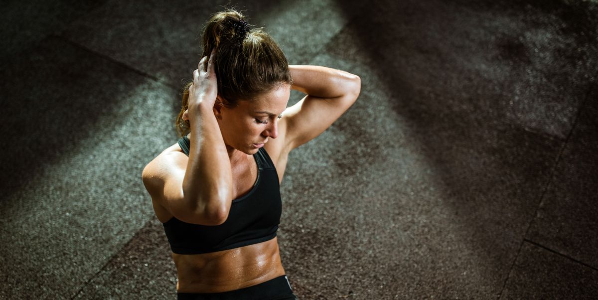 https://hips.hearstapps.com/hmg-prod/images/young-female-athlete-exercising-sit-ups-with-hands-royalty-free-image-1753895164.pjpeg?crop=1.00xw:0.752xh;0,0.125xh&resize=1200:*