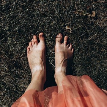 young female feet with a tan from shoes