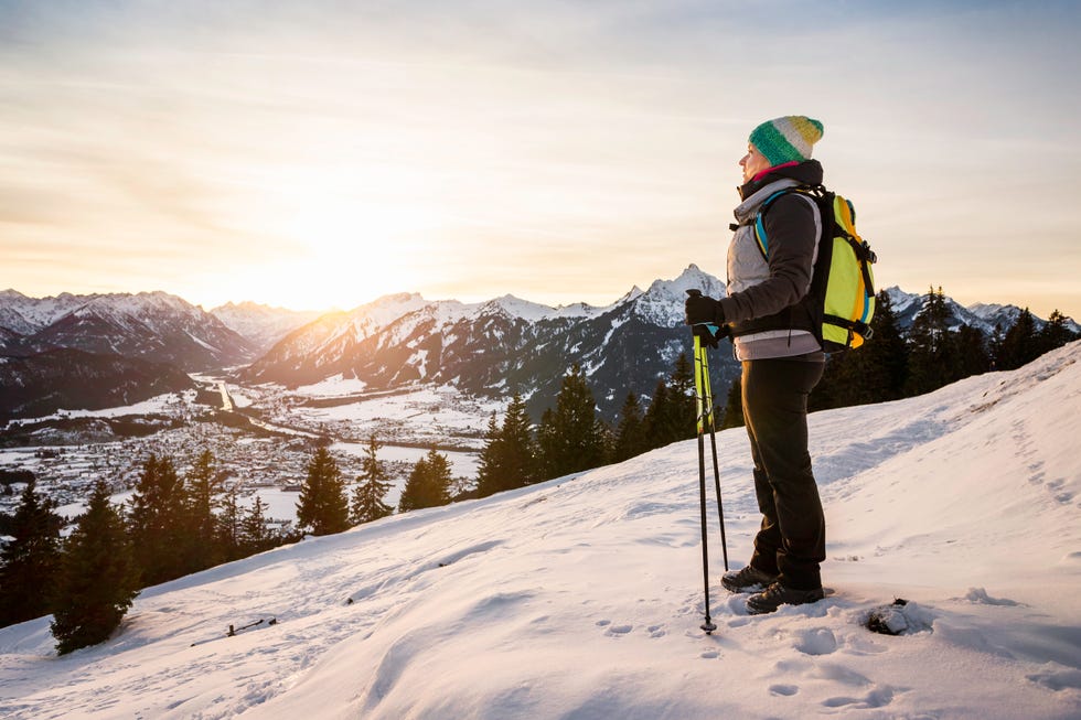 young female hiker looking out from mountainside, reutte, tyrol, austria