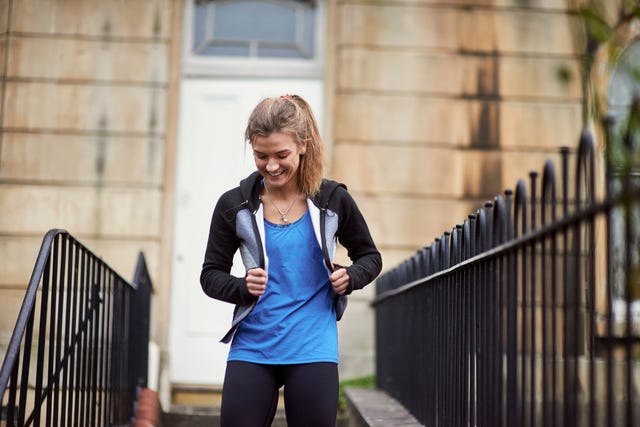 young female runner moving front door down stairway