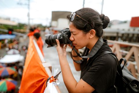 young filipino student photojournalist taking photographs