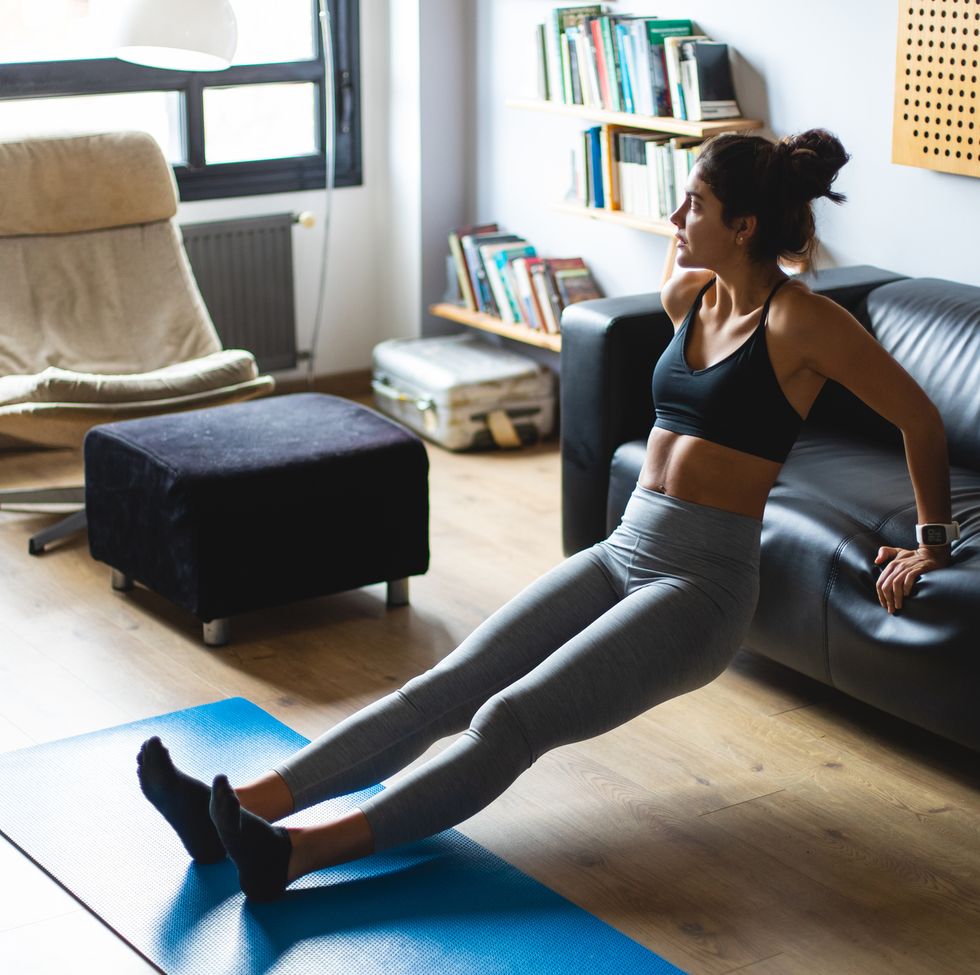 young fit woman exercising at home