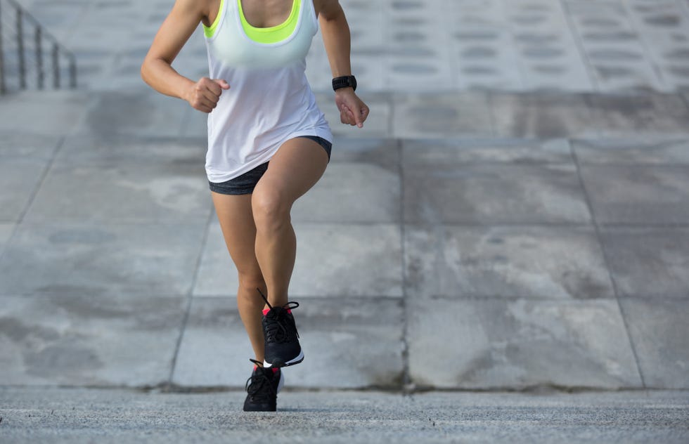 young fitness sports woman running upstairs on stone stairs