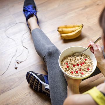 young girl eating oatmeal with berries after a workout fitness and healthy lifestyle concept