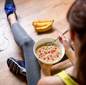 young girl eating oatmeal with berries after a workout fitness and healthy lifestyle concept