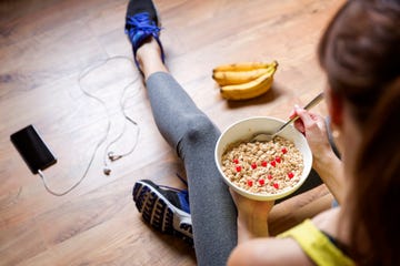 Young girl eating a oatmeal with berries after a workout . Fitness and healthy lifestyle concept.