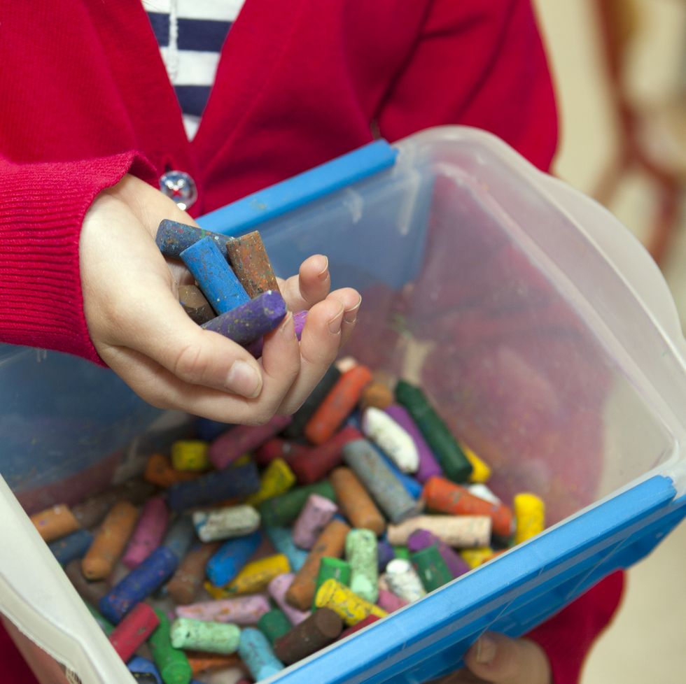 young girl holding pastel chalks