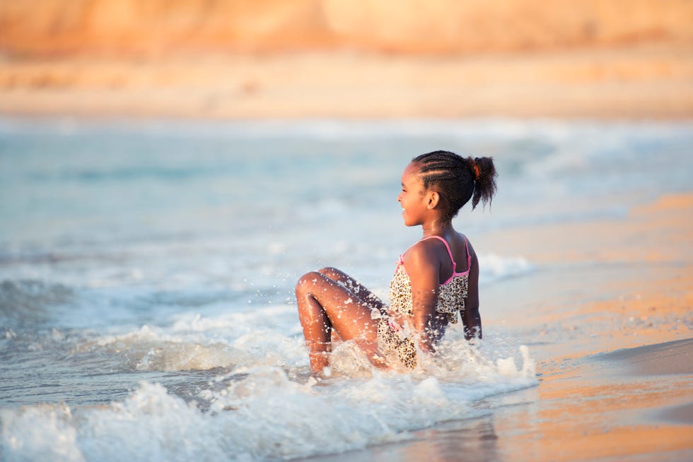 young girl crab walk in the mediterranean sea