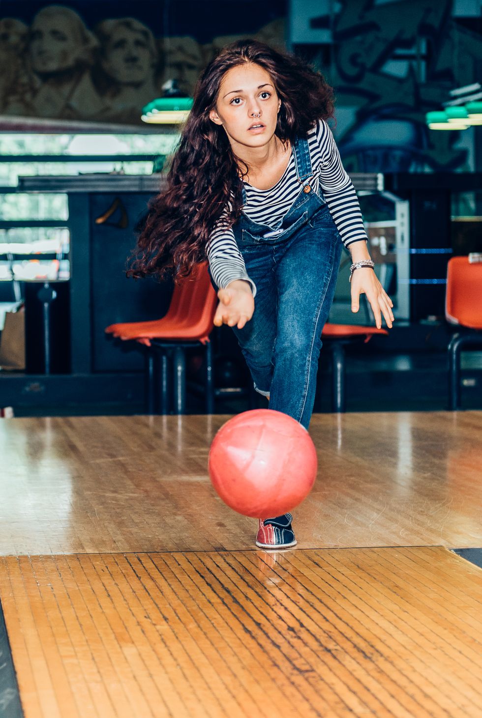 young girl plays bowling