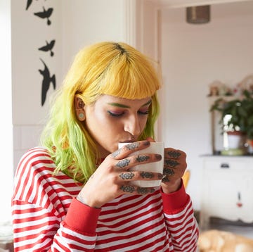 Young hipster woman drinking tea from a mug dry january benefits person sipping drink from mug